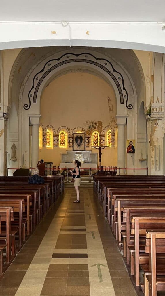 Interior of a grand Catholic church with wooden pews in Martinique France