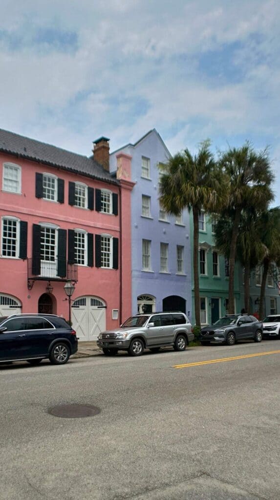 Pastel homes of Rainbow Row lining the street, an iconic backdrop for things to do in Charleston SC for couples

