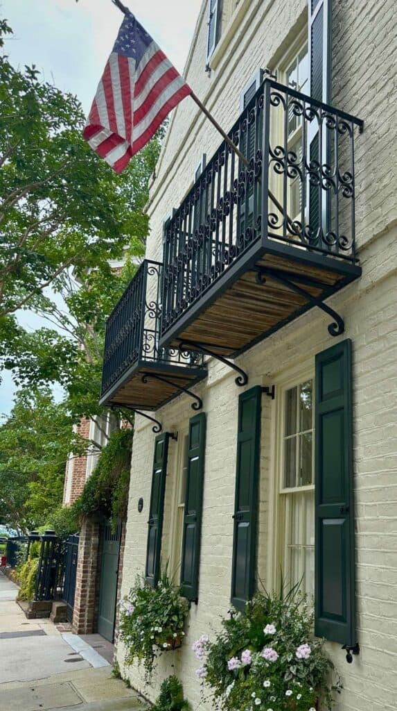 Historic home South of Broad with an American flag and flower boxes, ideal for romantic things to do in Charleston

