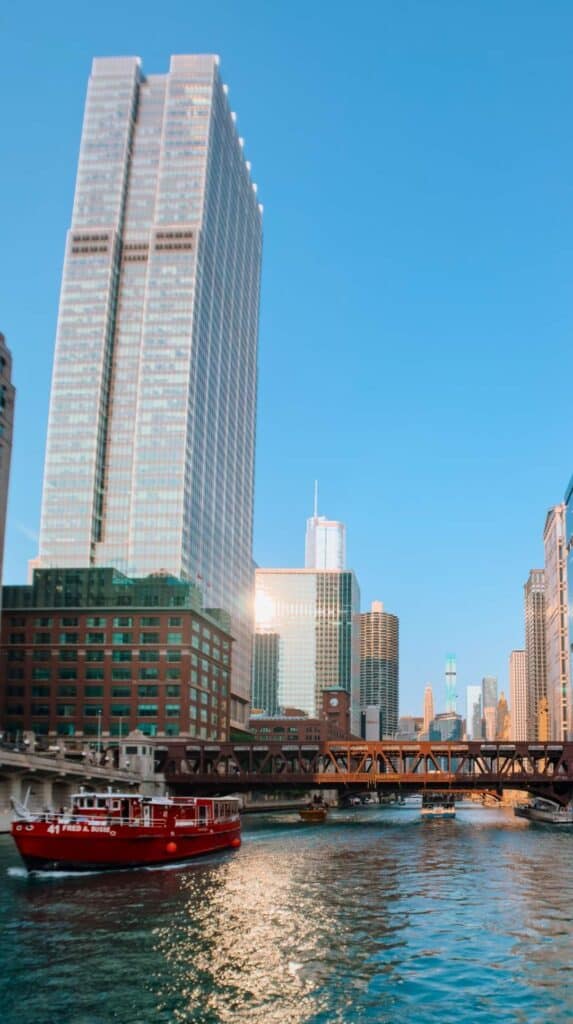 Red Wendella boat passing under a bridge on a 90 minute architecture boat tour chicago