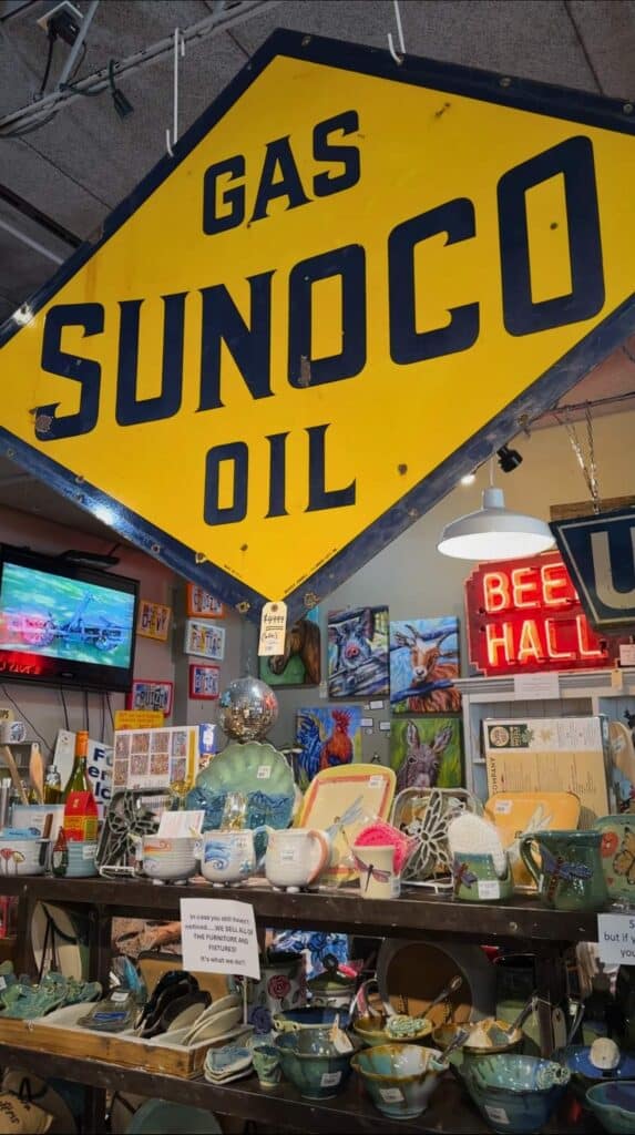 Interior of a coastal themed shop filled with vintage decor, signs, and home goods in downtown Ocean Springs Mississippi.