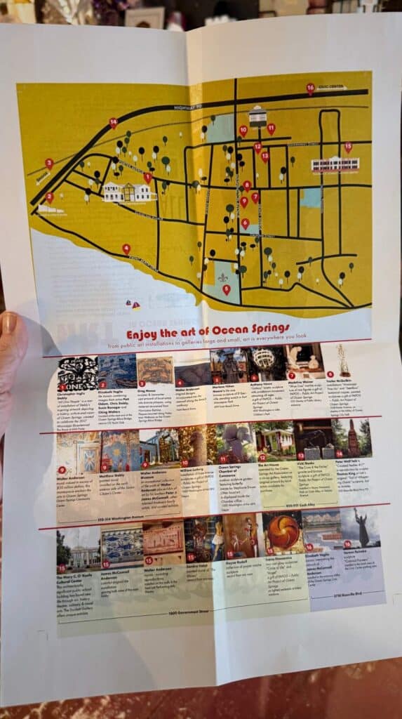 Folded brochure map titled "Enjoy the Art of Ocean Springs" showing a layout of downtown with marked public art locations and descriptions below.