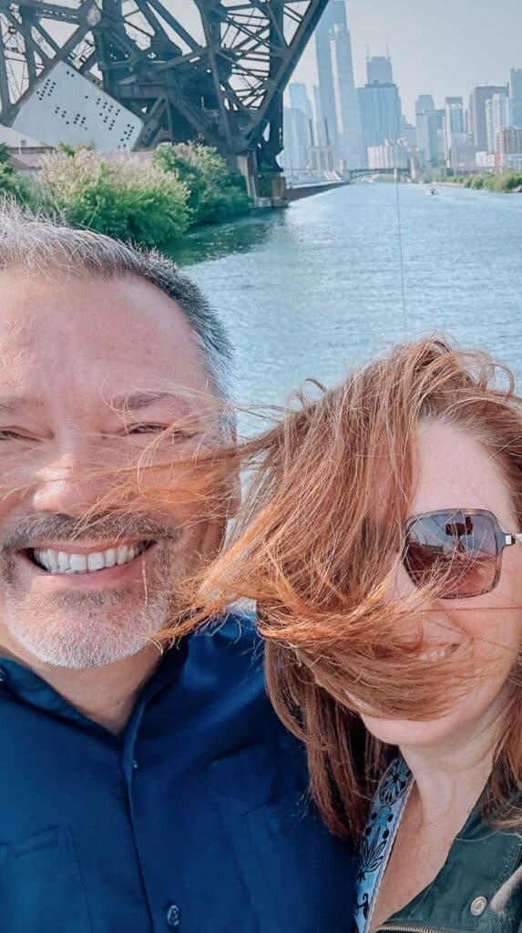Windblown couple selfie with the skyline on a chicago architecture boat tour