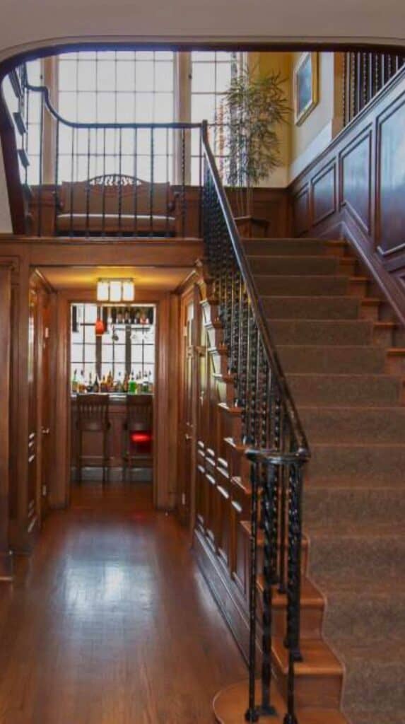 Wood-paneled staircase and historic interior hallway inside Bluff View Inn highlighting the charm of this historic Chattanooga stay.