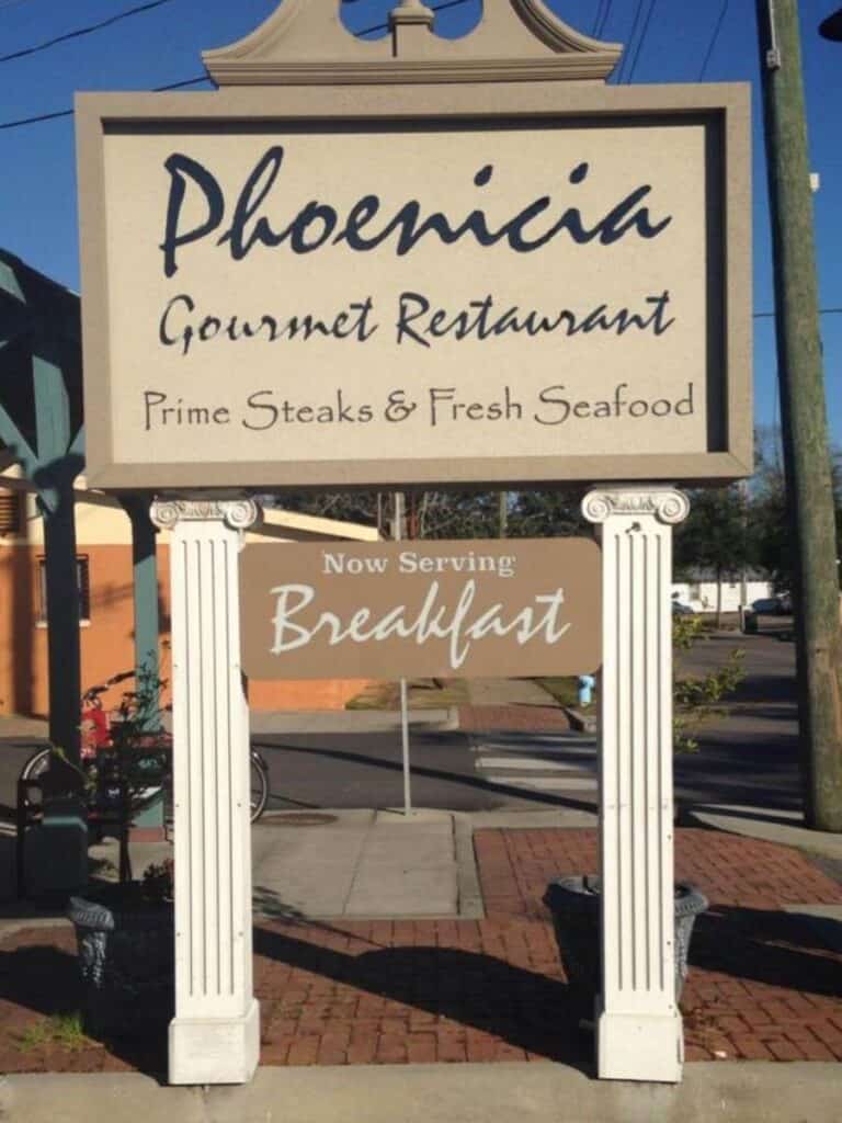 The Phoenicia Gourmet sign advertising steaks, seafood, and breakfast, a solid choice for lunch in Ocean Springs any day.