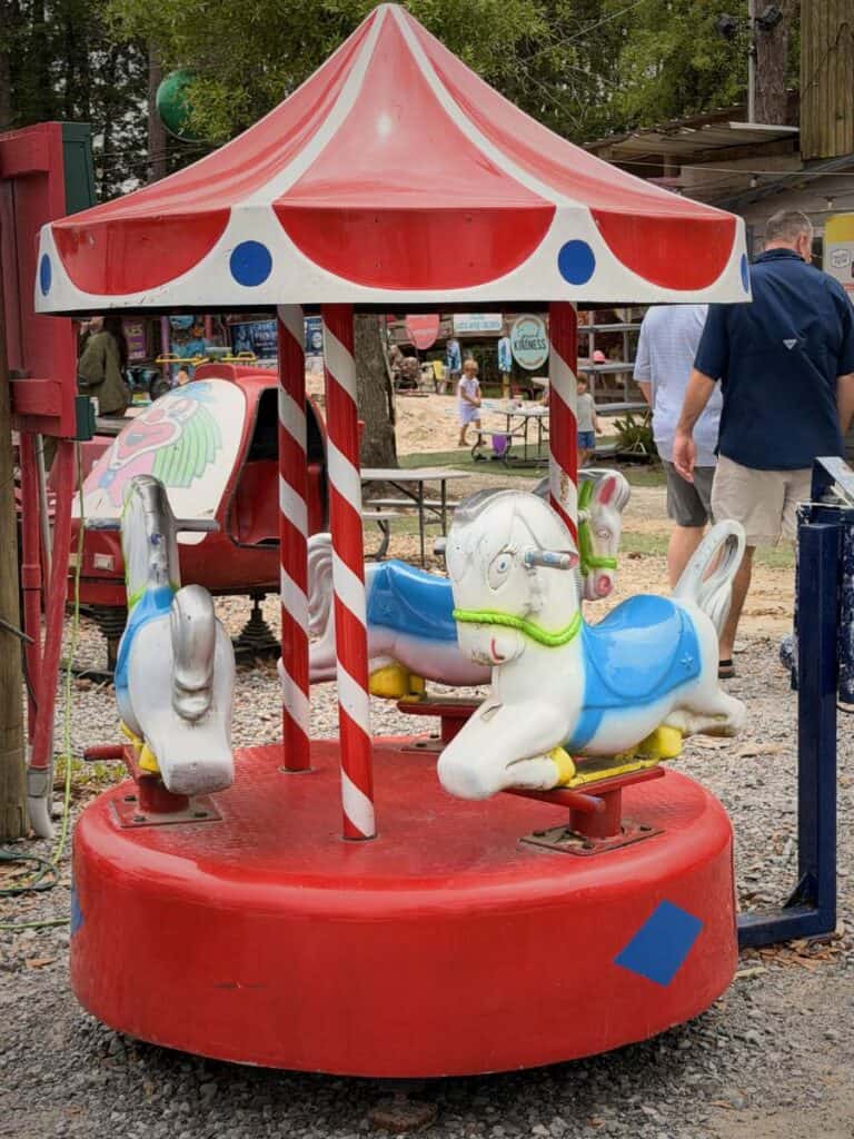 A vintage kiddie carousel at The Shed, nostalgic charm at one of the quirkiest Ocean Springs restaurants to visit.