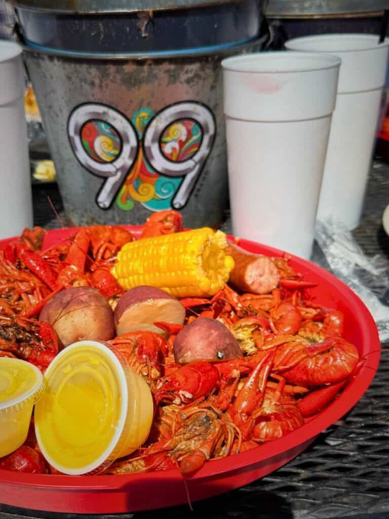 Large tray piled with boiled crawfish spread across a table, highlighting a classic meal at restaurants in Ocean Springs MS.