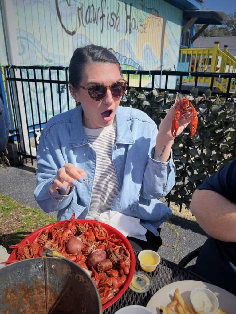 Outdoor dining area with people eating seafood at The Crawfish House, a lively spot for seafood in Ocean Springs Mississippi.