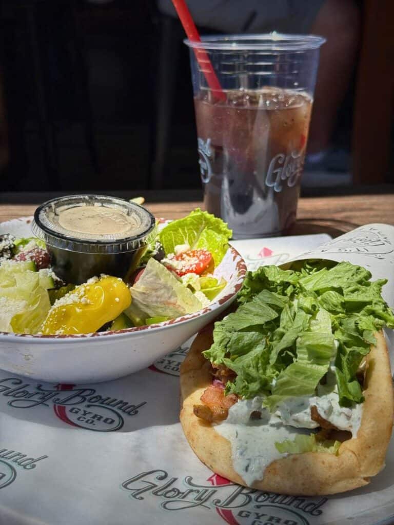 Gyro wrapped in pita filled with meat and vegetables topped with sauce, representing Mediterranean options when deciding where to eat in Ocean Springs MS.