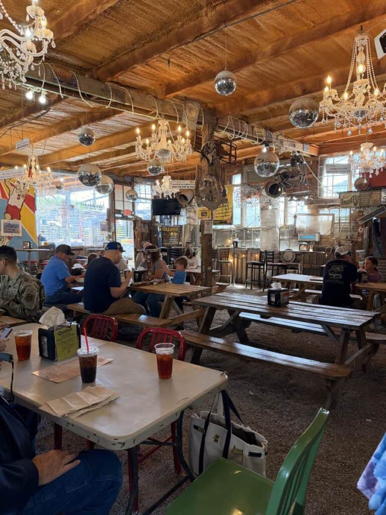 Ceiling covered with chandeliers and disco balls inside a quirky barbecue restaurant near Ocean Springs Mississippi.