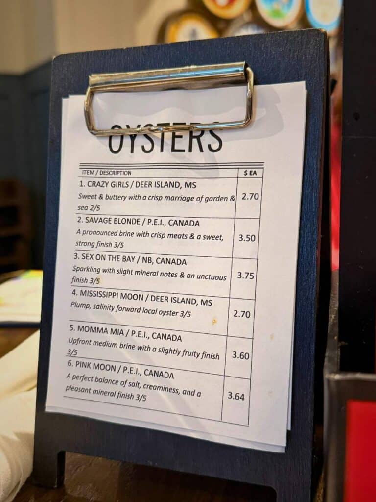 Oyster menu board with multiple preparation options displayed at Keg and Barrel, a popular seafood and bar spot in Ocean Springs.