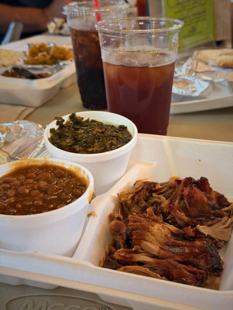 Plate with barbecue meat and sides served as a smaller portion meal, representing family friendly dining in Ocean Springs MS.