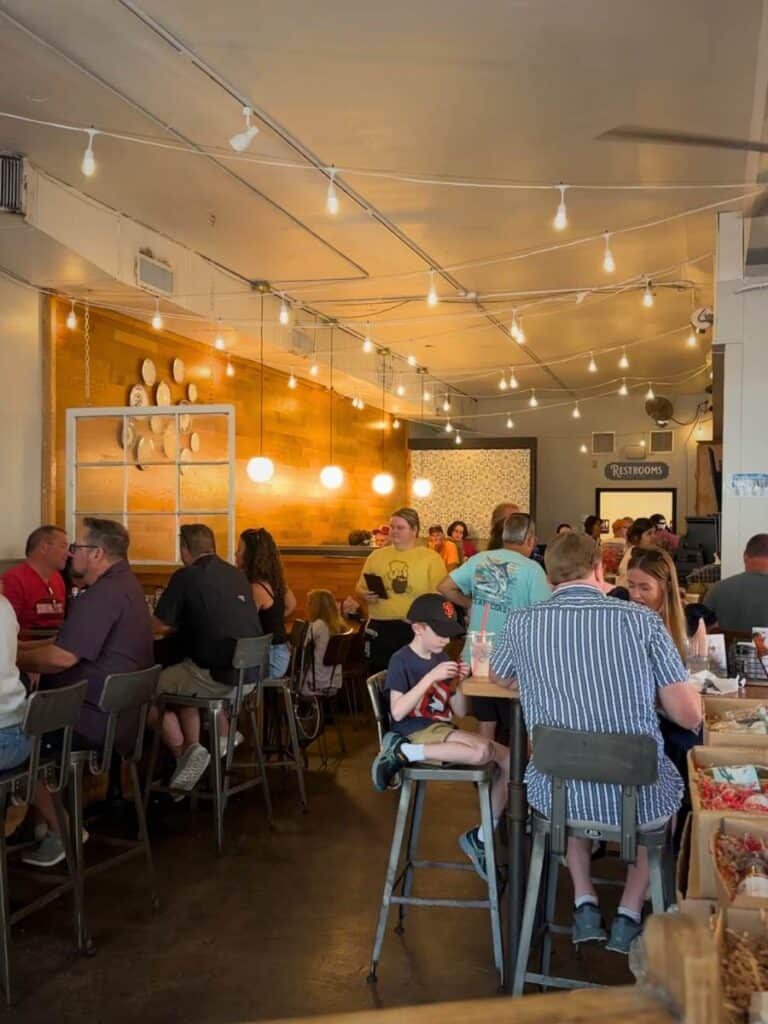 The busy string-lit interior of The Lady May, one of the Best places to eat in Ocean Springs, MS for lunch or dinner.