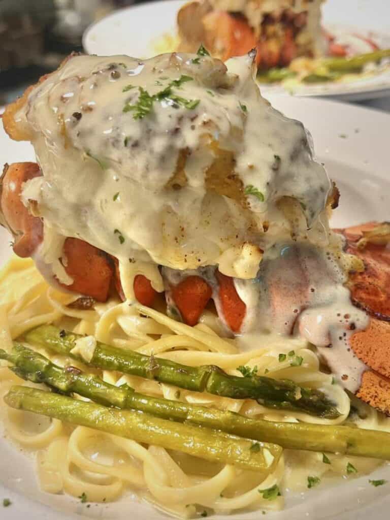 Creamy lobster pasta with asparagus at Maison de Lu, one of the Best places to eat in Ocean Springs, MS for dinner.