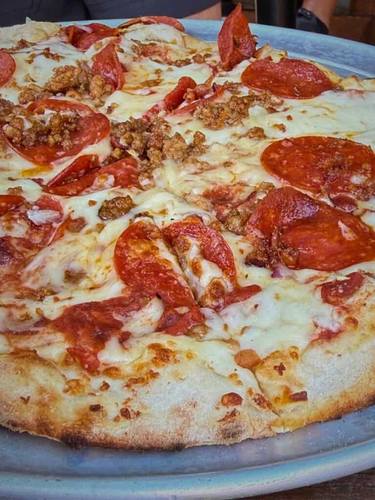 A pepperoni and sausage pizza at Glory Bound Gyro Co, showing where to eat in Ocean Springs beyond Mediterranean food.