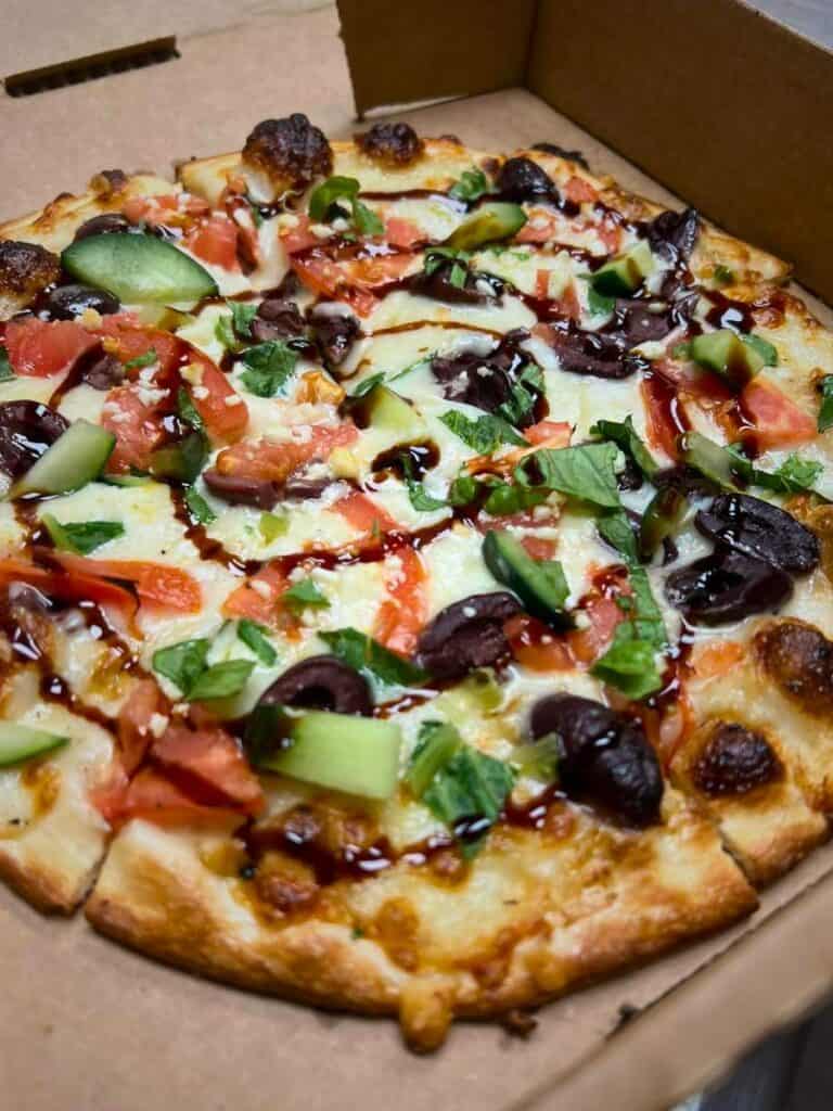 A loaded specialty pizza at Tom's Extreme Pizzeria, a favorite best restaurant Ocean Springs, MS for pizza night.