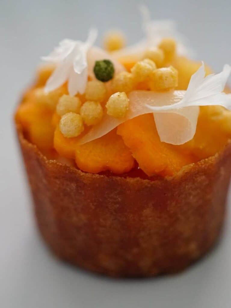A delicate flower-topped tart at Vestige, fine dining at one of the most acclaimed Ocean Springs restaurants around.