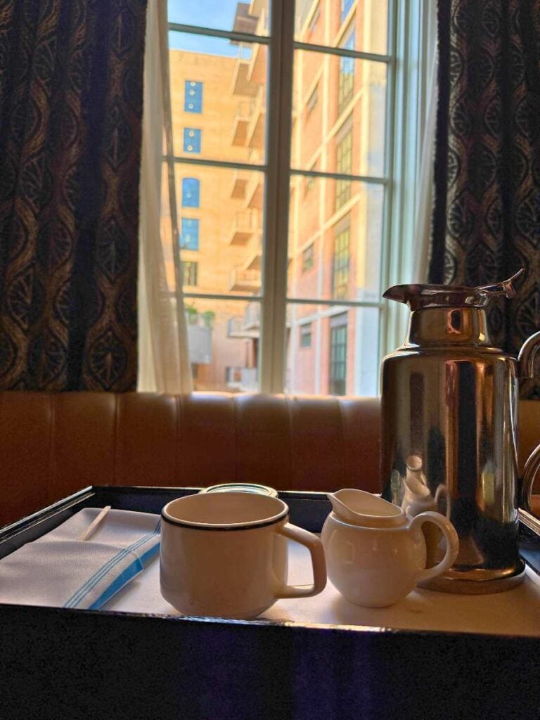 Silver carafe and mug from the complimentary coffee service brought to our Hotel Emma room
