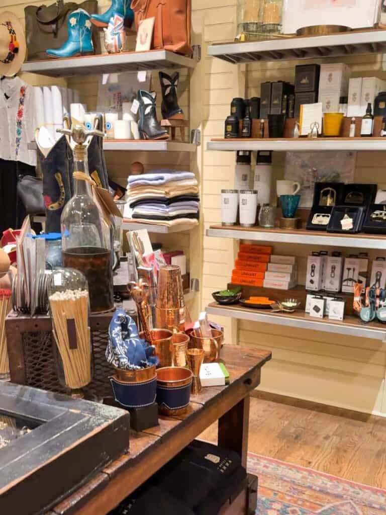 Curio shop at Hotel Emma stocked with local goods, cowboy boots, copper cups, and merch