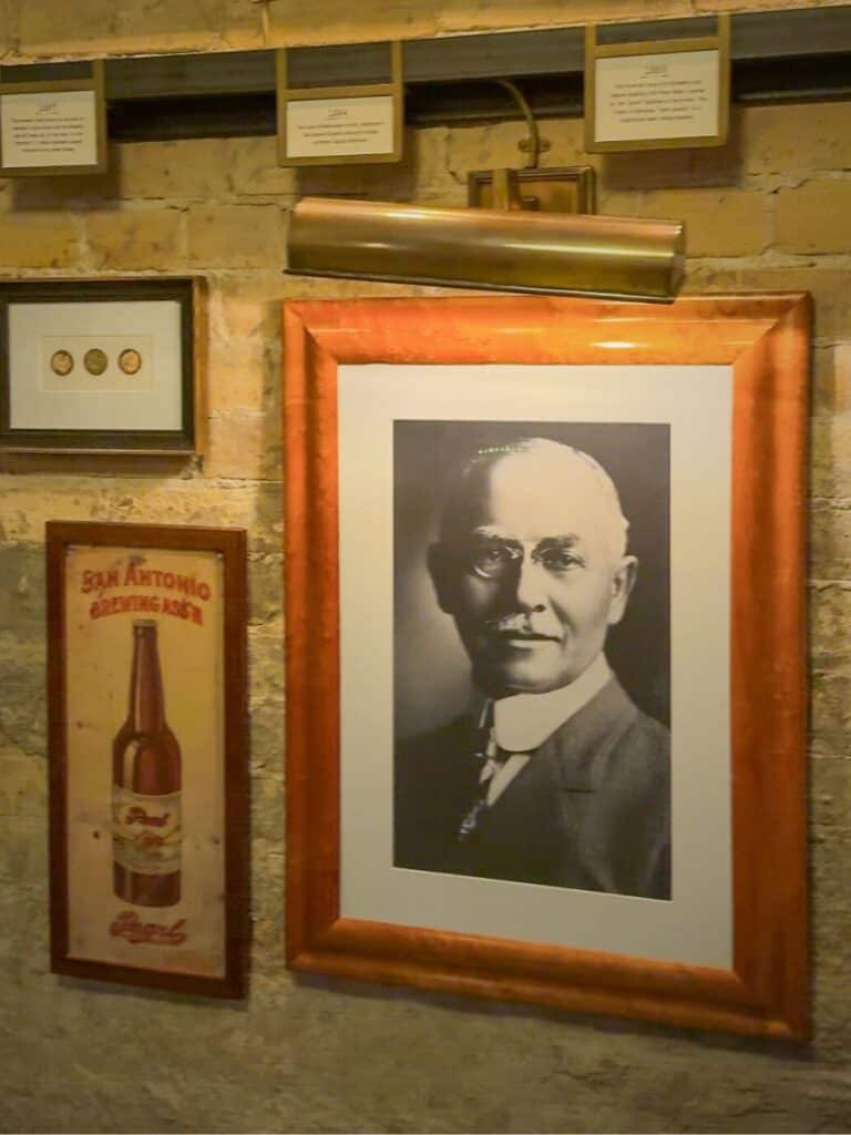 Framed portrait of brewery founder Otto beside a San Antonio Brewing sign, part of the Hotel Emma history
