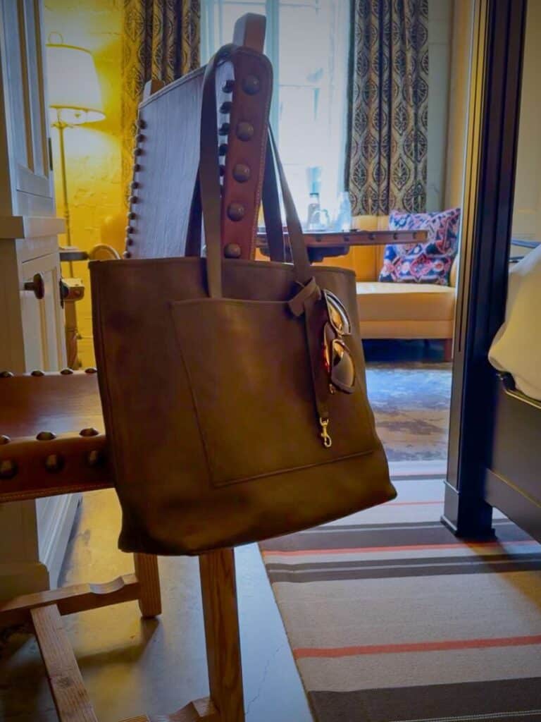 WP Standard leather tote hanging on a chair, a souvenir from the Hotel Emma San Antonio Curio shop