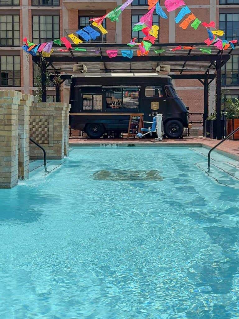 Rooftop pool at Hotel Emma with the Provisions food truck bar and colorful Fiesta banners