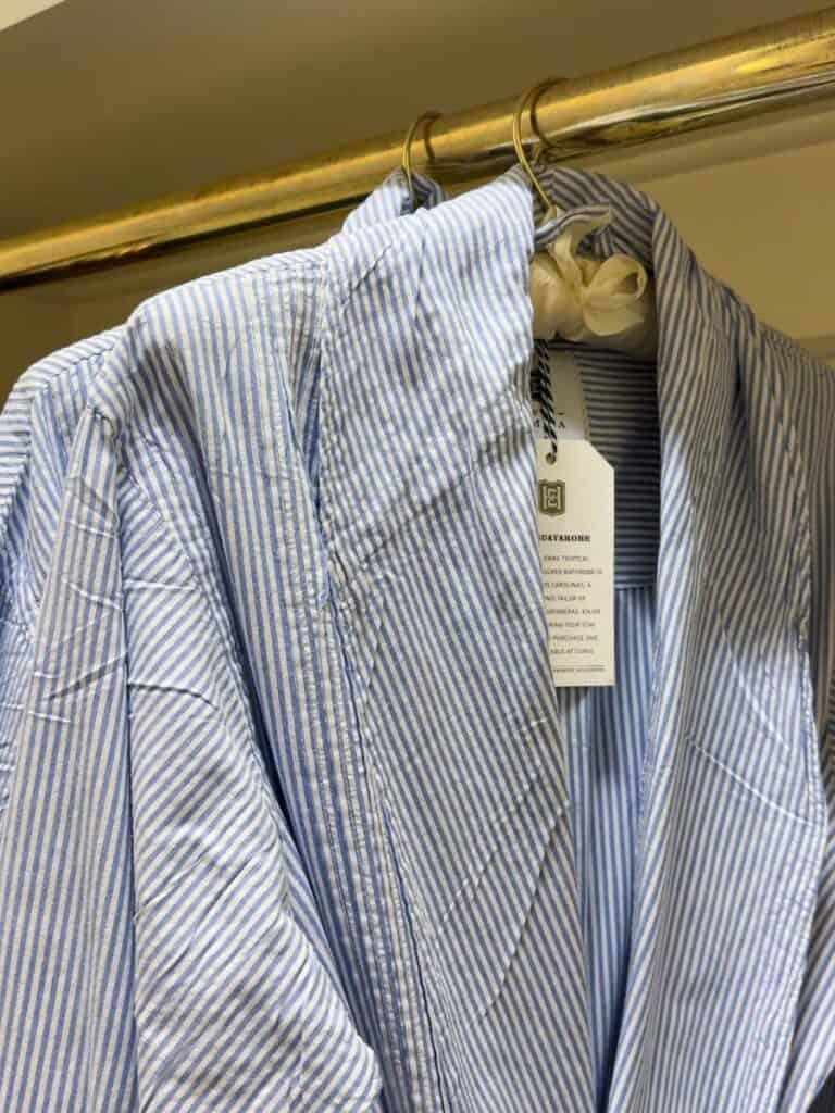 Blue striped guayabera robes by Dos Carolinas hanging in a Hotel Emma closet