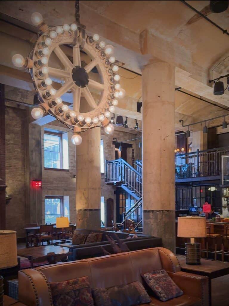 Sternewirth at Hotel Emma San Antonio with its wheel-shaped chandelier over worn leather sofas