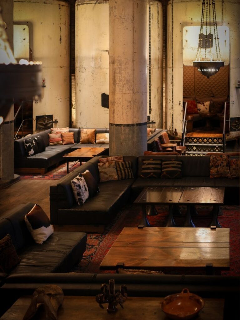 Sternewirth lounge at Hotel Emma San Antonio with low leather seating between towering columns