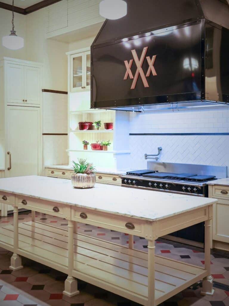 Demonstration kitchen with a black range hood and white island at Hotel Emma in the Pearl