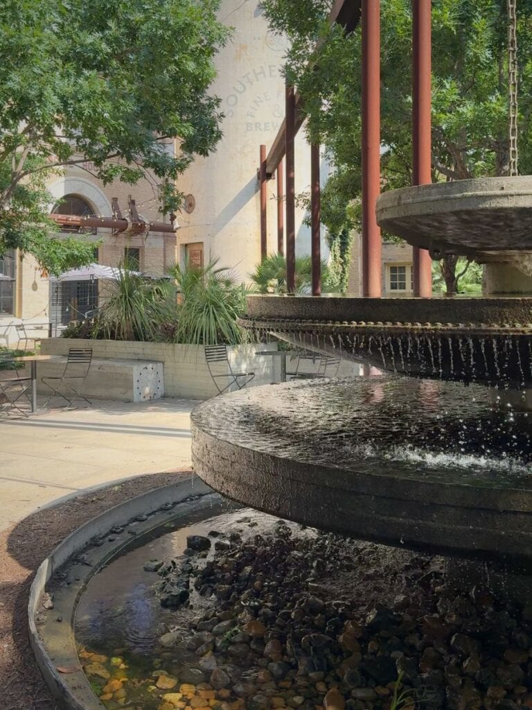 Tiered stone fountain in the Pearl courtyard outside Hotel Emma San Antonio near the old brewery