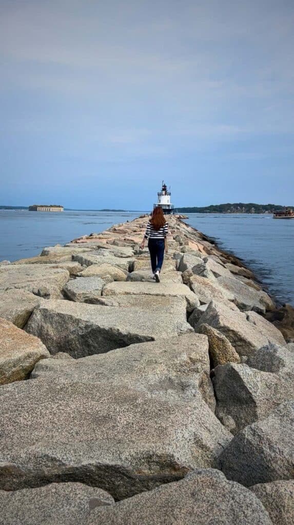 Walking the long stone breakwater toward Portland's Spring Point Ledge Light

