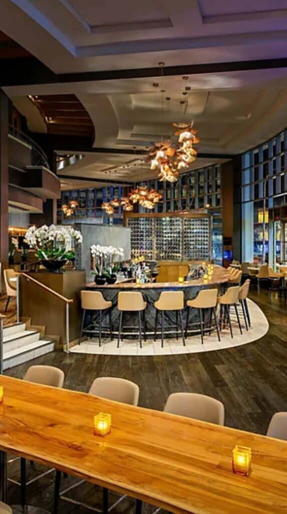 Modern hotel restaurant with bar seating and warm lighting at a Vancouver cruise port hotel.