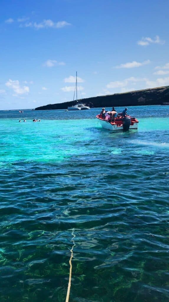 Turquoise water and a small motorboat near the shore during a Martinique snorkeling excursion