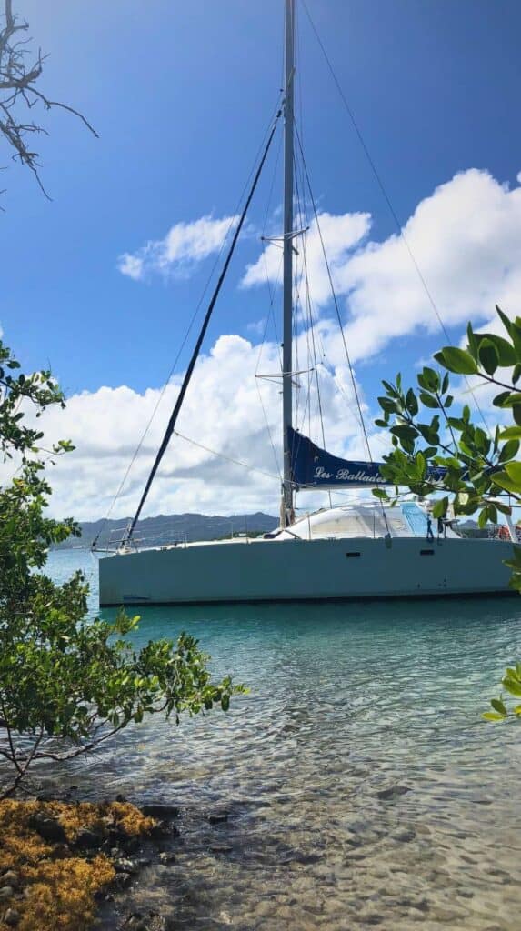 Catamaran anchored in clear shallow water at one of the best places to stay in Martinique