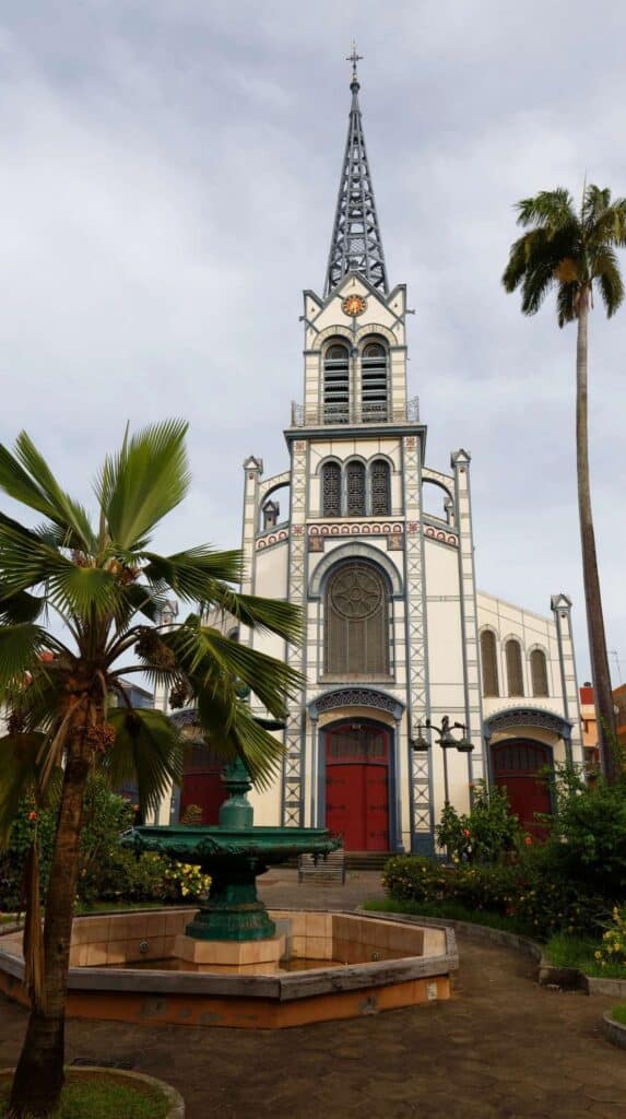 Cathedral in Fort-de-France with a decorative fountain and palm trees on a Martinique shore excursion
