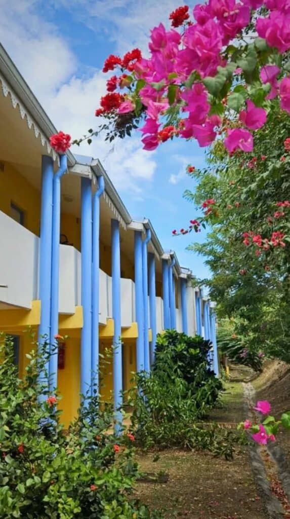 Les Cayalines hotel exterior with blue columns showing what hotels in Martinique look like