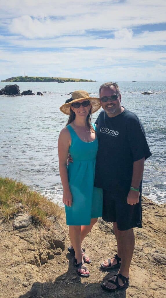 Couple posing on a rocky Martinique coastline showing where to stay in Martinique near the sea