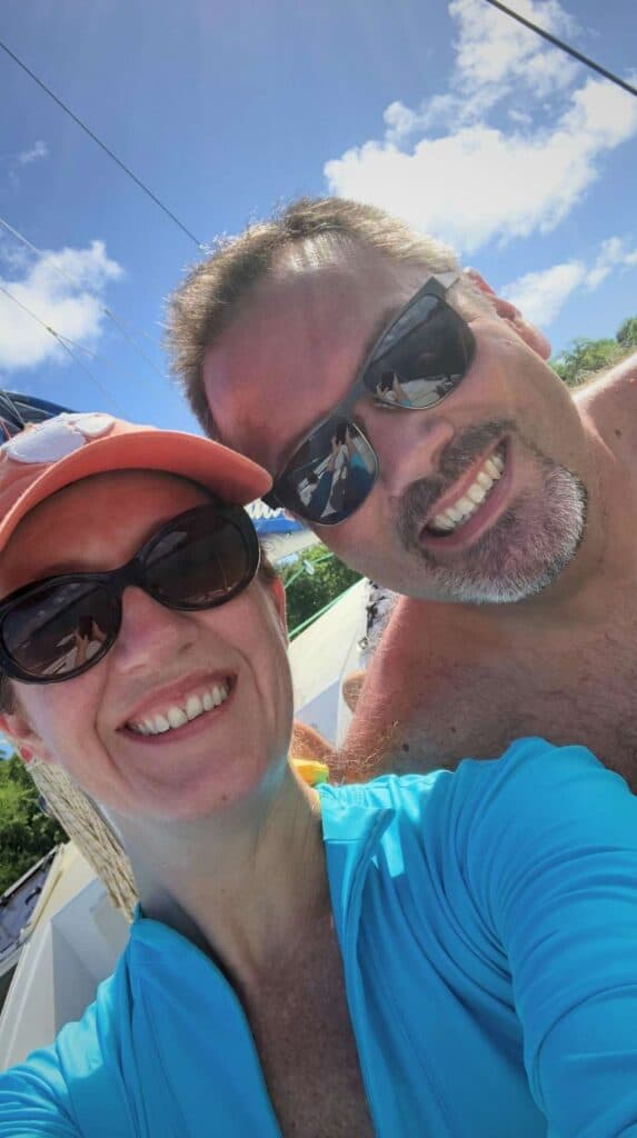 Couple taking a selfie on a catamaran day trip arranged through vacation rentals in Martinique