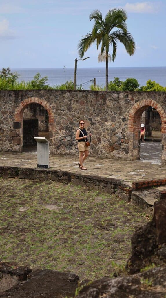 Woman exploring Saint-Pierre ruins a short drive from where to stay in Martinique in the north