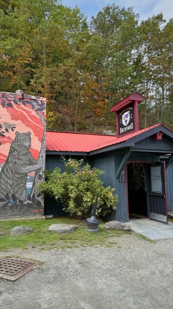 A red painted building with a black bear mural along the Kancamagus Highway
