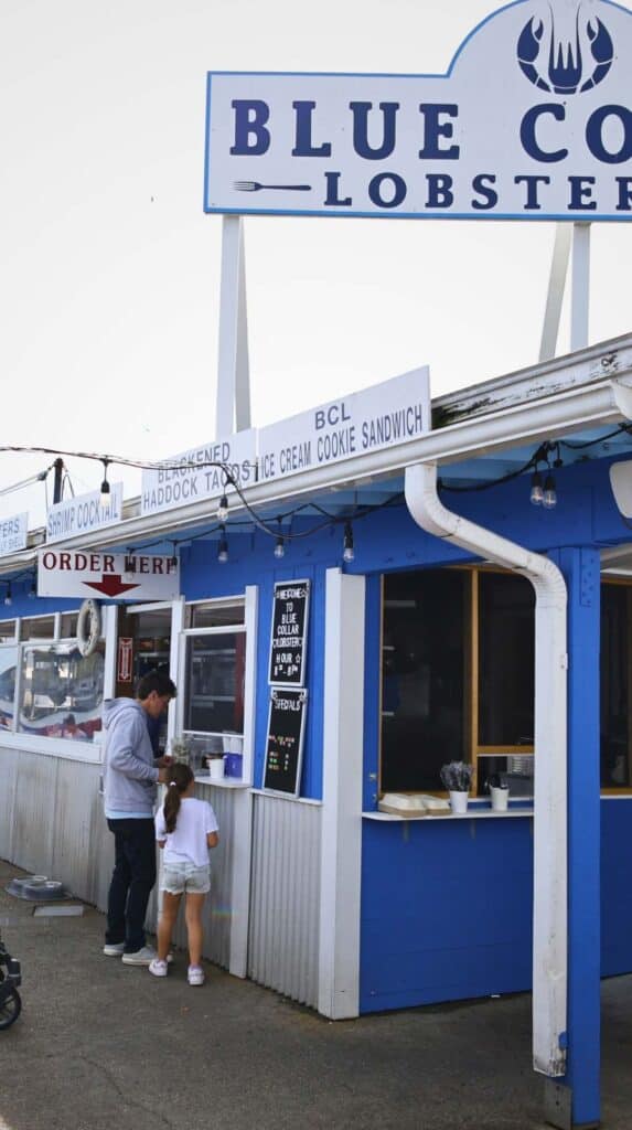 Ordering fresh seafood at the Blue Collar Lobster Co takeout window in Gloucester
