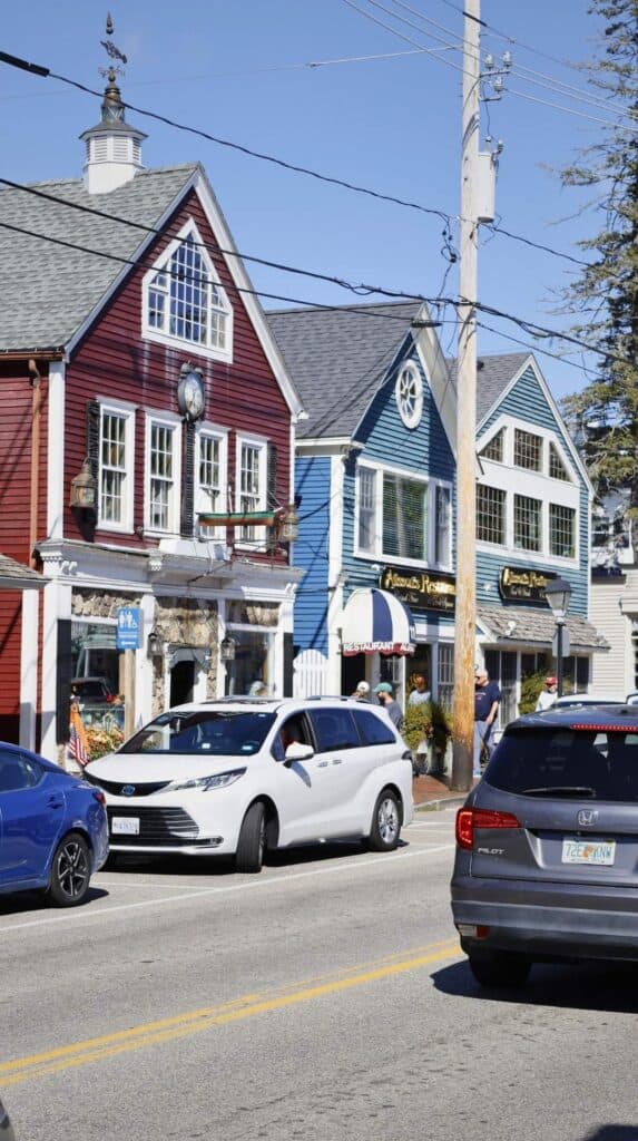 Pastel storefronts line the main street of Kennebunkport, Maine
