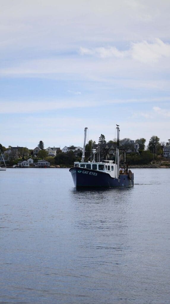 A lobster boat motors across the harbor near Gloucester, Massachusetts
