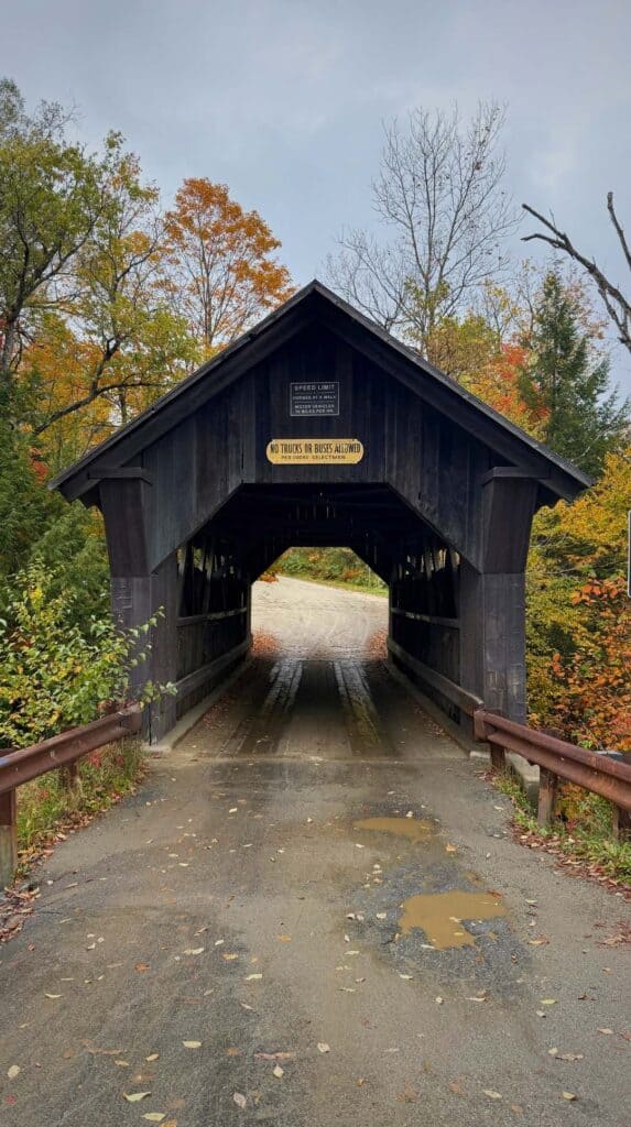 Walking through the weathered Gold Brook Covered Bridge, known as Emily's Bridge
