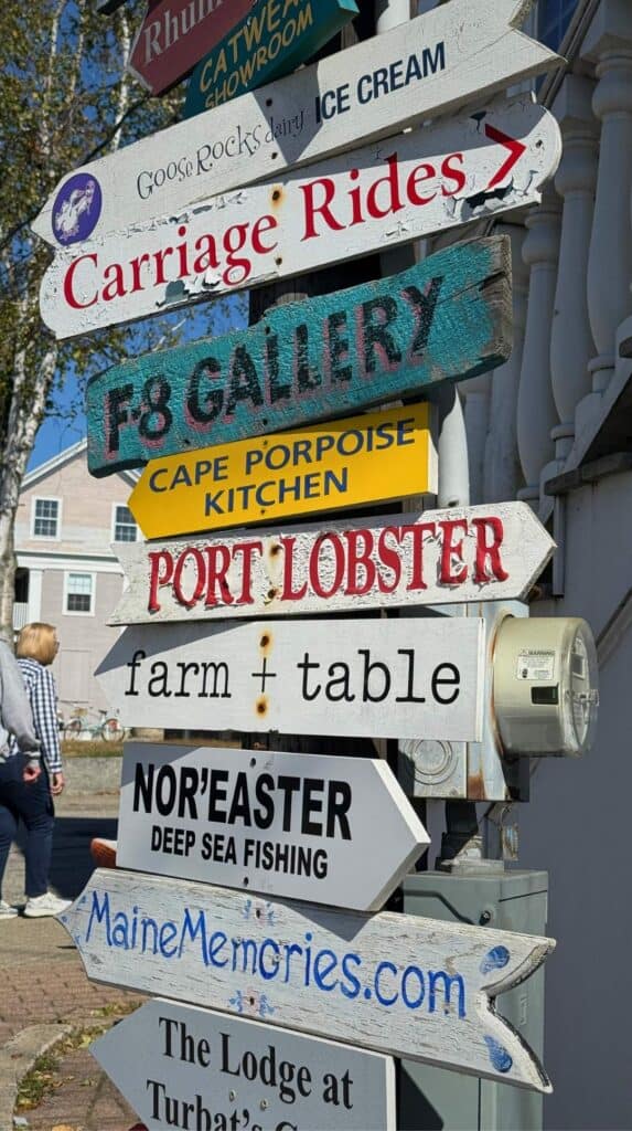 Colorful directional signs point the way to shops and lobster spots in Cape Porpoise
