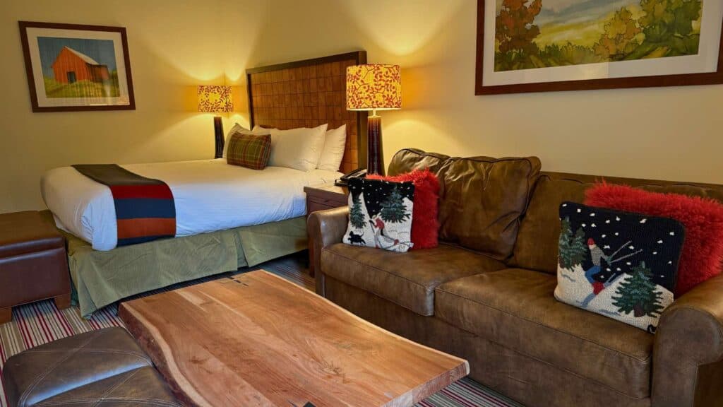 A cozy suite with fall themed pillows at The Lodge at Spruce Peak
