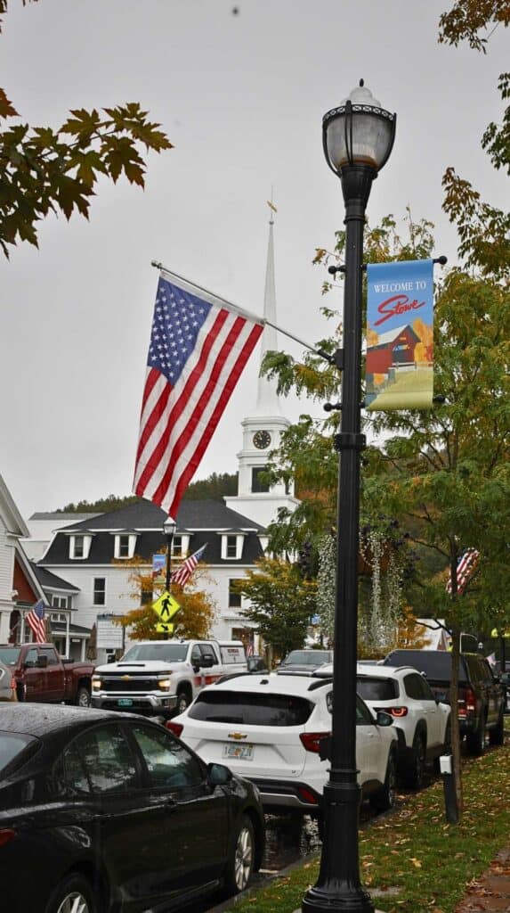 An American flag waves along Main Street in Stowe, Vermont
