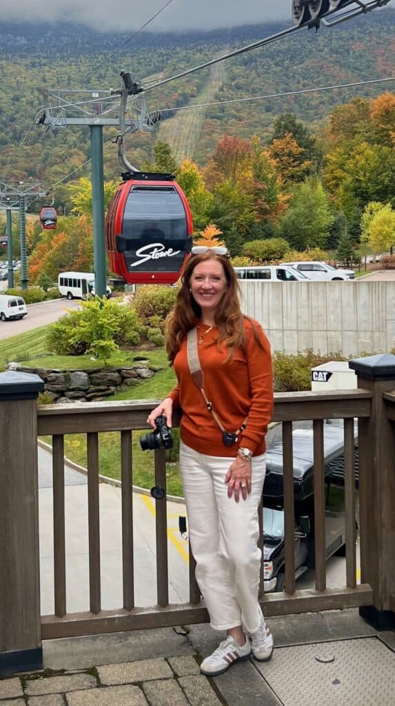 Posing near the gondola with the Green Mountains foliage behind her in Stowe
