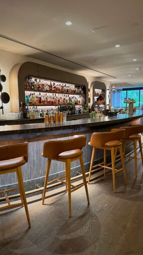 A warmly lit bar area inside The Lodge at Spruce Peak in Stowe
